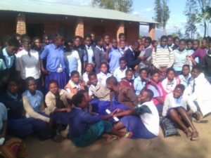 Participants to the second Girl Shower at Namphungo Community Day Secondary School pose for a group photograph during the shower